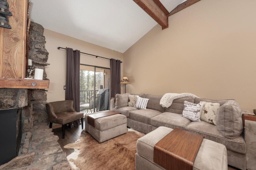 a living room with a couch and a fireplace at Beaver Village Unit #2031 in Winter Park