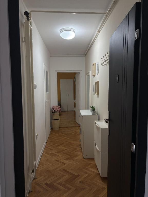 a hallway with a bathroom with a sink and a toilet at City Vibes in Subotica