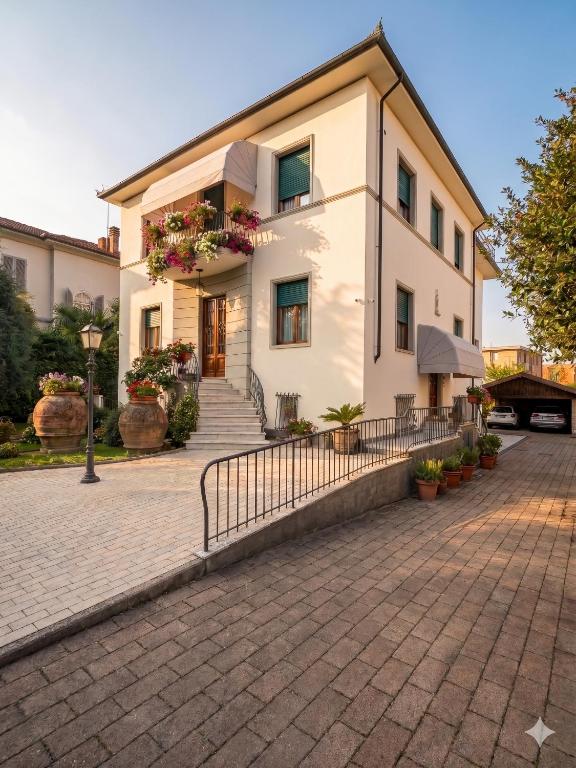 a large white building with flower boxes on it at Villa alle Mura in Lucca