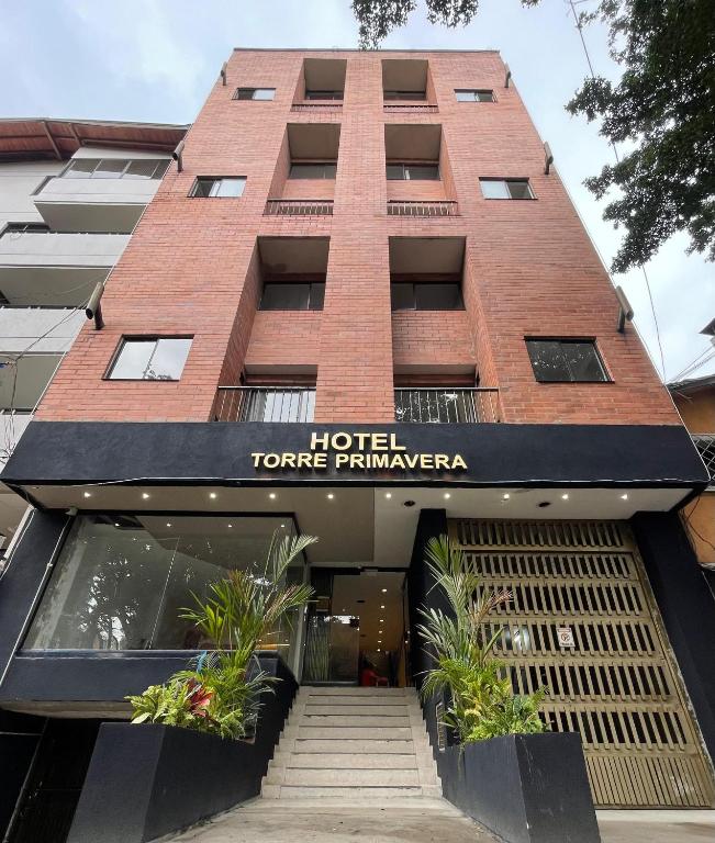 a hotel entrance with a sign that reads hotel tangerine runaway at Hotel Torre Primavera in Medellín