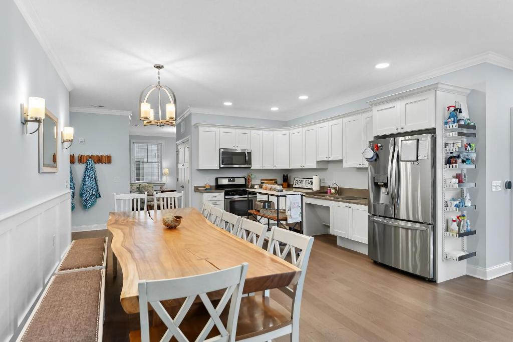 a kitchen with white cabinets and a wooden dining table at 8609 Landis Ave, Condo 201 in Sea Isle City