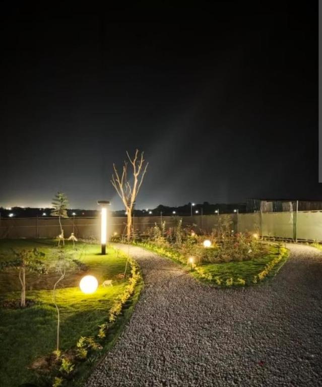 a garden at night with lights in the grass at Sabaki's Homely One bedroom Apartment - Near JKIA, Airport in Marimbeti