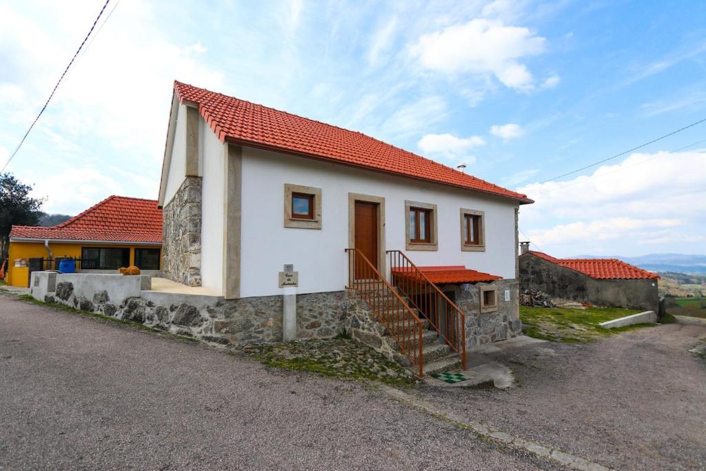 a small white house with a red roof at Casa da Madrinha - Paredes de Coura in Paredes de Coura