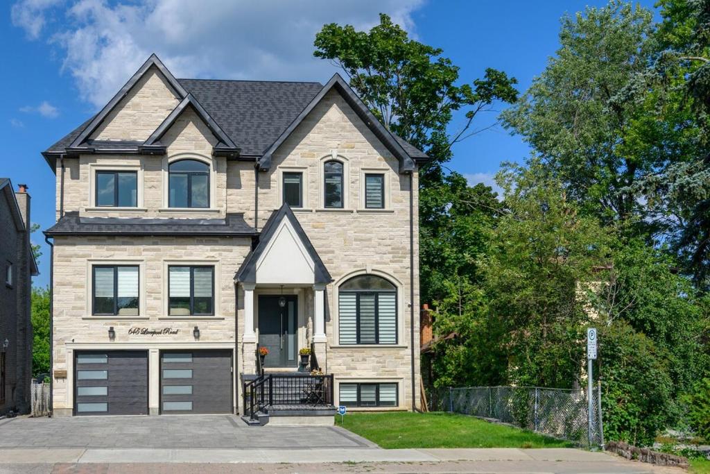 a brick house with a garage at Beach House First Floor in Pickering