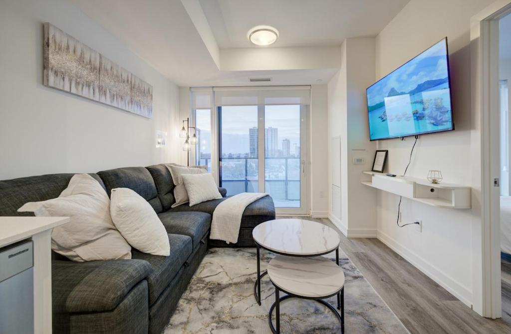 a living room with a couch and a table at Modern & Stylish Condo Downtown KW in Kitchener