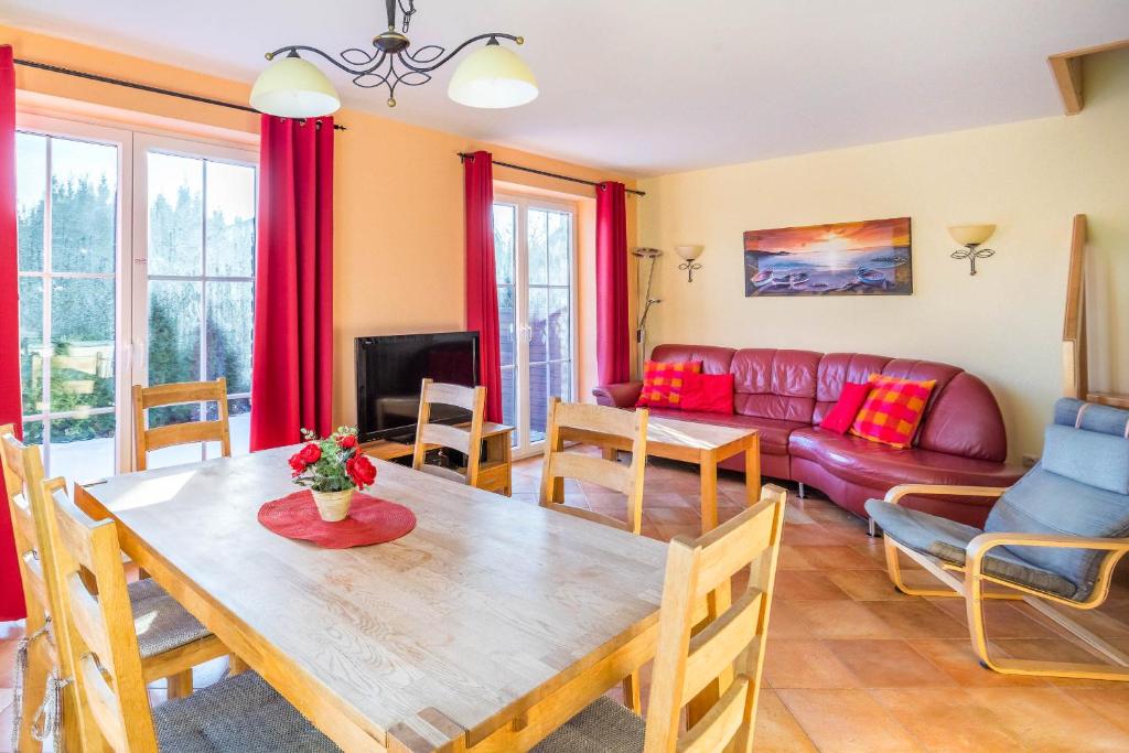 a living room with a table and a couch at Ferienhaus Mandy in Wohlenberg