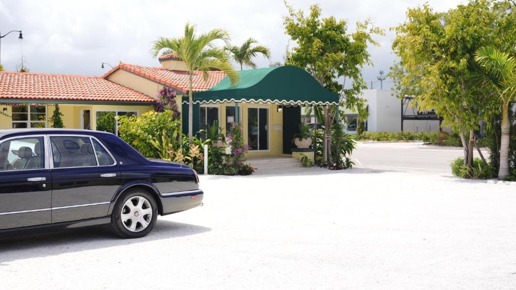 a car parked in front of a house at The Palm Rose in West Palm Beach