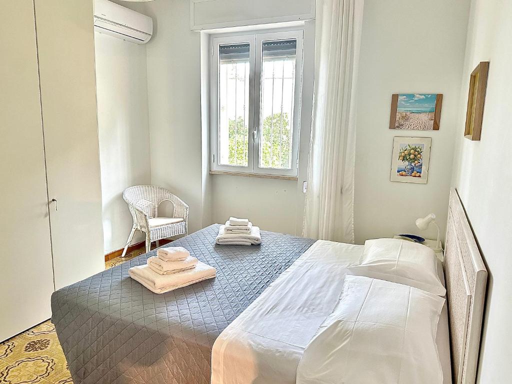 a bedroom with a bed with two towels on it at Villa Oleandera a Polignano a Mare in Polignano a Mare