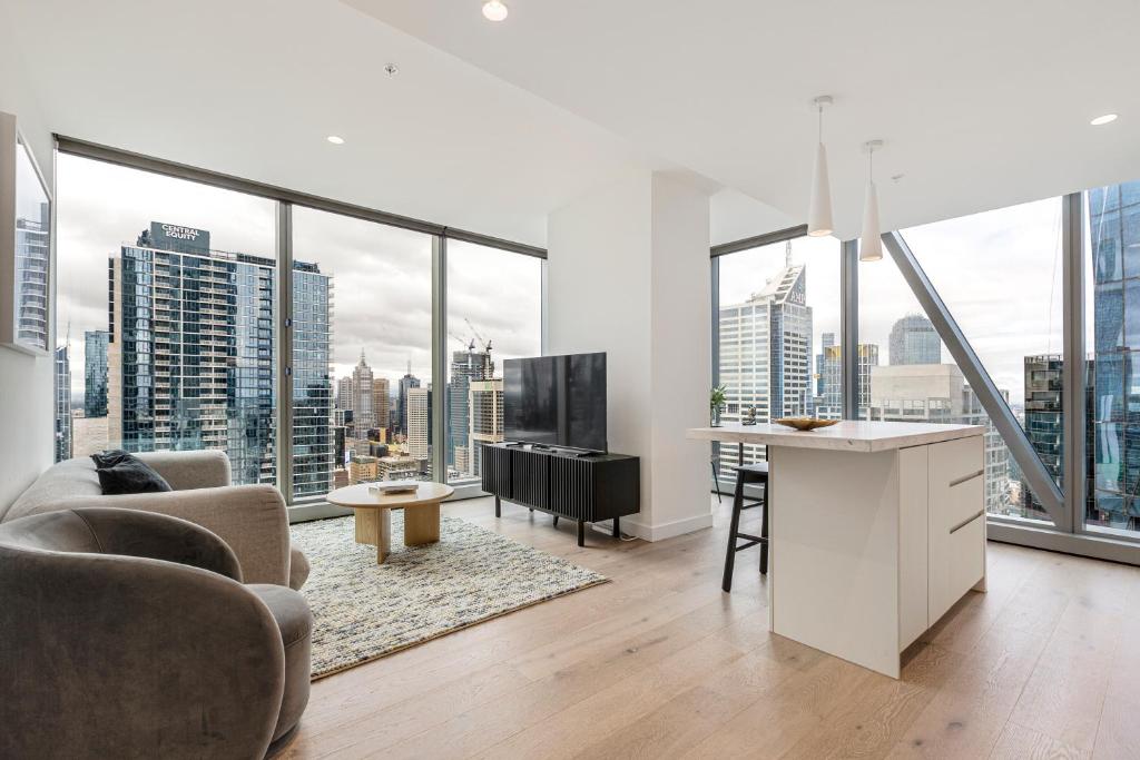 a living room with a view of a city at Spencer on Rock in Melbourne
