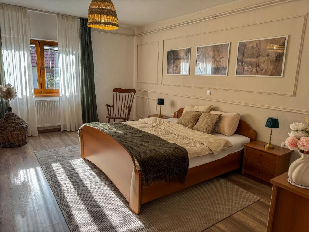 a bedroom with a bed and a chair at Hiša Štanfl in Osilnica