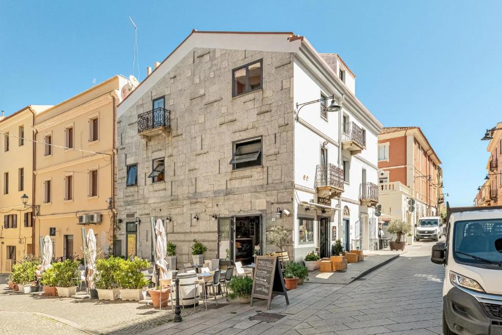 a stone building on a street in a city at Gaias Rooms in Olbia