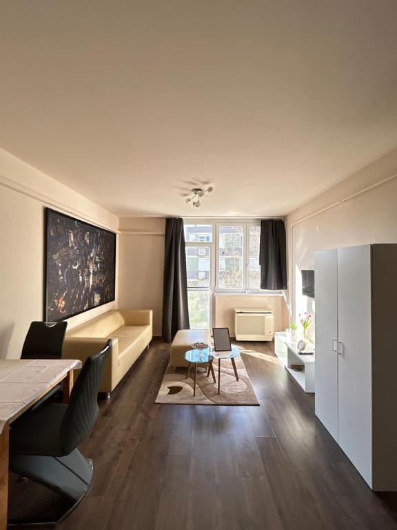 a living room with a couch and a table at Szántó Prime Residence in Szolnok