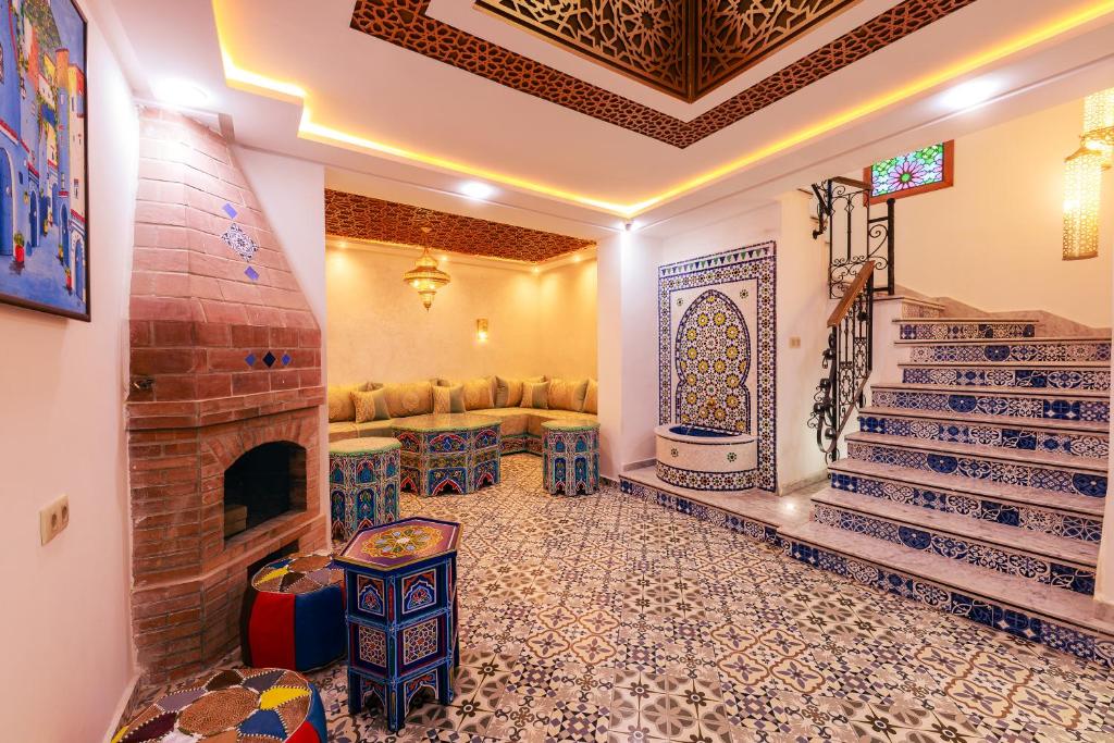 a living room with a fireplace and a couch at Riad Seddiki in Chefchaouen
