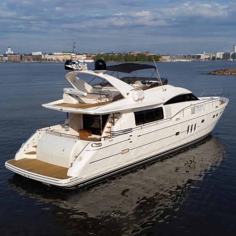 a white boat floating in the water at The Lux Yachts - Luxury Private Yacht Experience in Helsinki