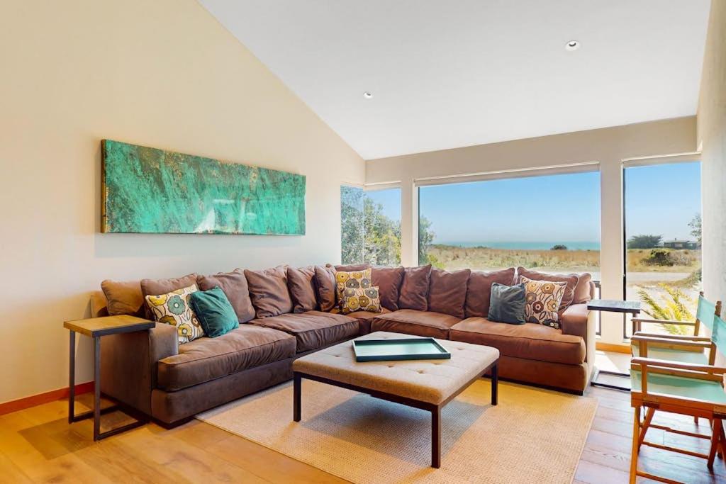 a living room with a brown couch and a table at West Meadow in Sea Ranch