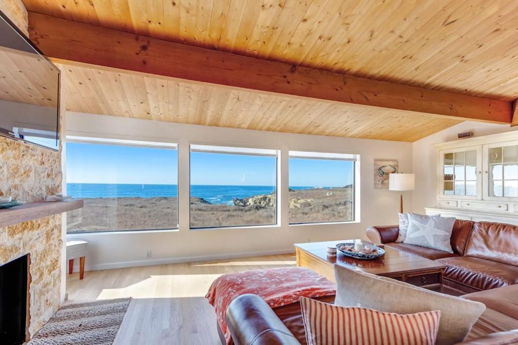 a living room with a couch and some windows at Del Mar Point in Sea Ranch