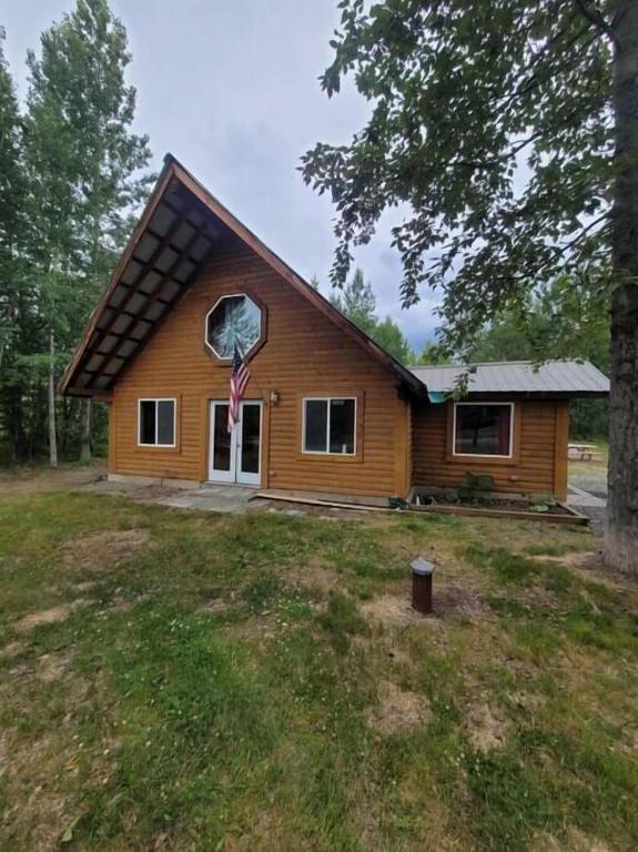a small house with a window on the side of it at Sterling Cabin close to Kenai River in Sterling