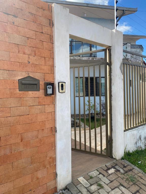 a door to a building with a gate at Studio sattwa 2 in Prudentópolis
