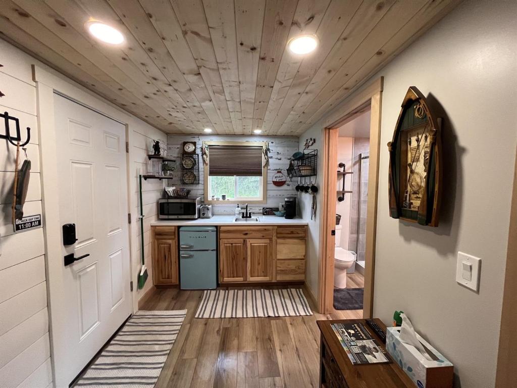 a kitchen with a sink and a stove at Catch'em AK - Salmon Cove in Soldotna