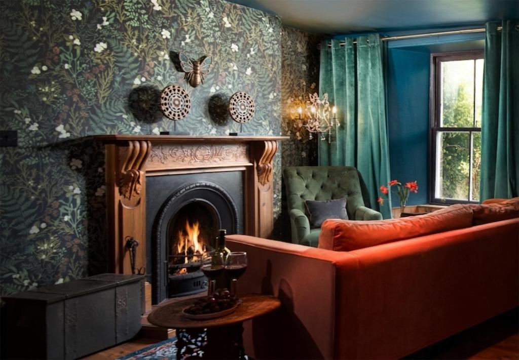 a living room with a couch and a fireplace at Wonderland Berwick 5-bedrooms Pet-friendly cottage with the Hot tub in Tweedmouth
