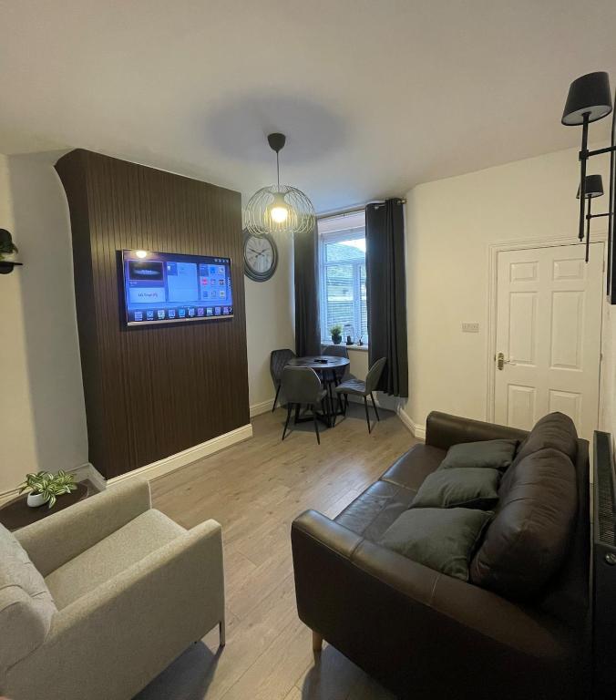 a living room with a couch and a table at Modern Homes in Stoke on Trent