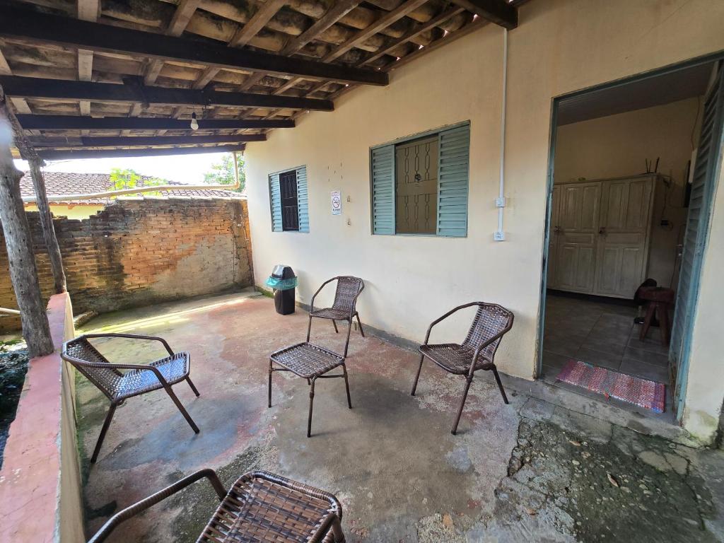 a group of chairs sitting on a patio at MAEVE Albergue in Goiás