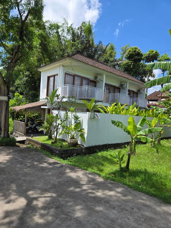 a house in the middle of a yard at Villa Fireflies in Darmasaba