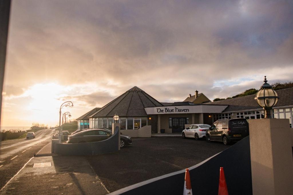a building with cars parked in a parking lot at The Blue Haven Kilcar in Donegal