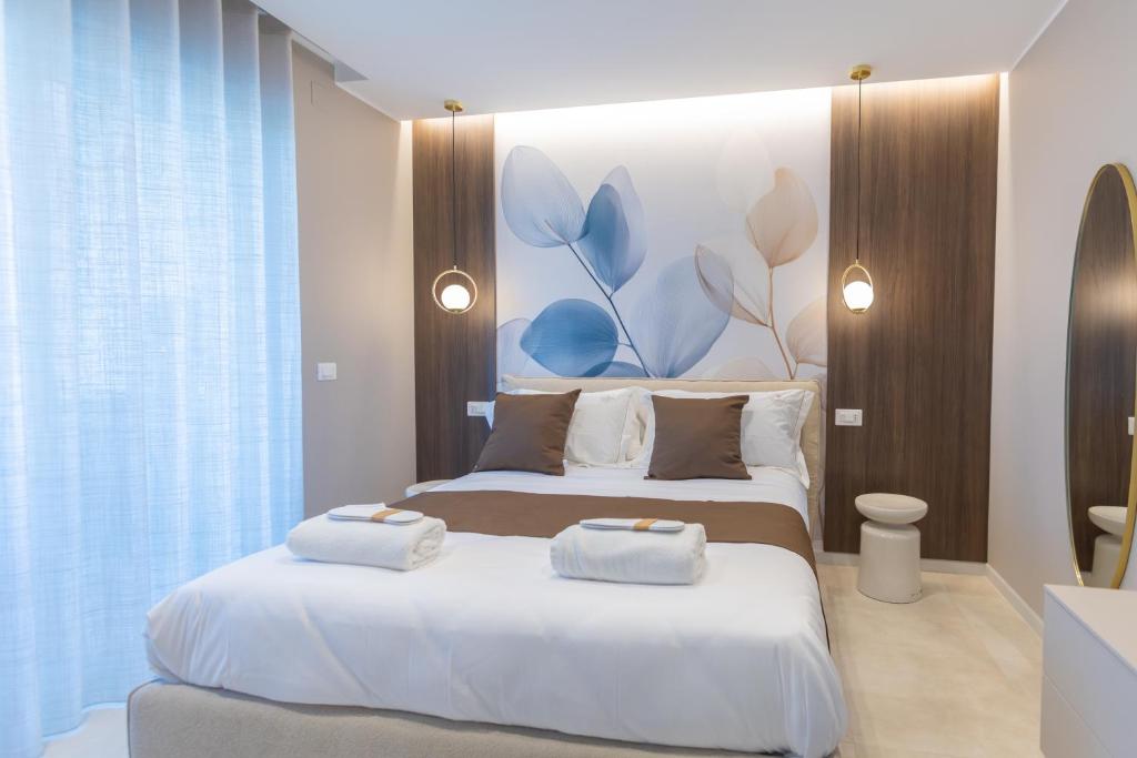 a bedroom with two beds with towels on them at Campo's Guest House Airport in Bari