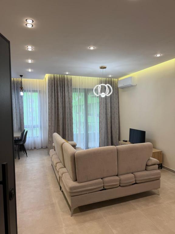 a living room with a large couch in a room at Tirana Urban Nest in Tirana