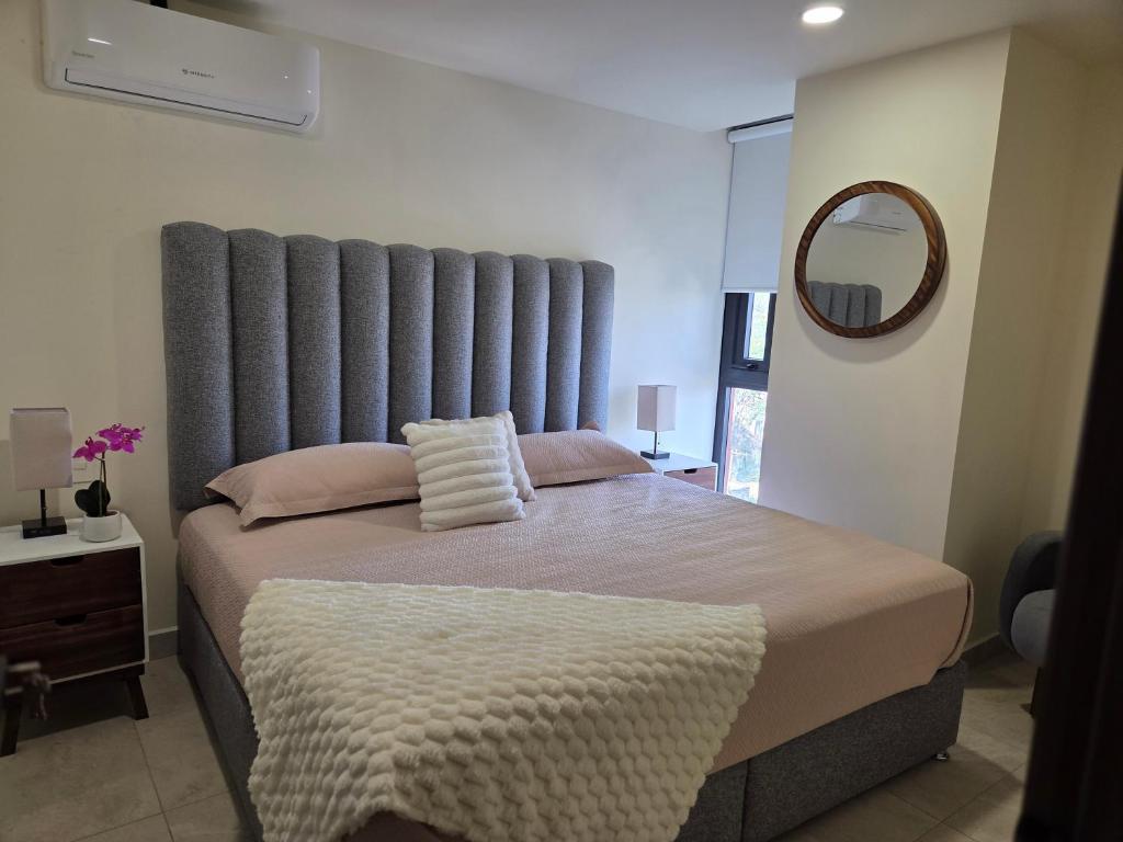 a bedroom with a large bed with a large headboard at Apartment in downtown Zapopan in Guadalajara