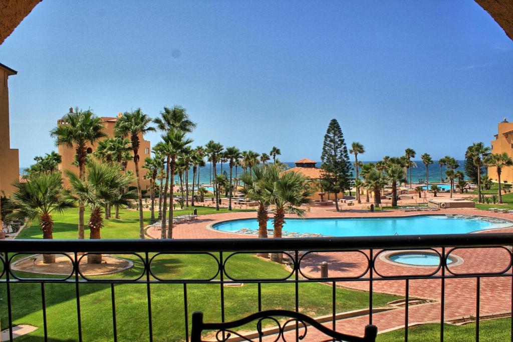 a view from the balcony of a resort with a swimming pool at Princesa C206 -Arcade Game-Experience Rocky Point- in Puerto Peñasco