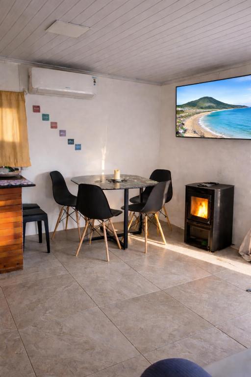 a dining room with a table and a fireplace at Renacer in Piriápolis