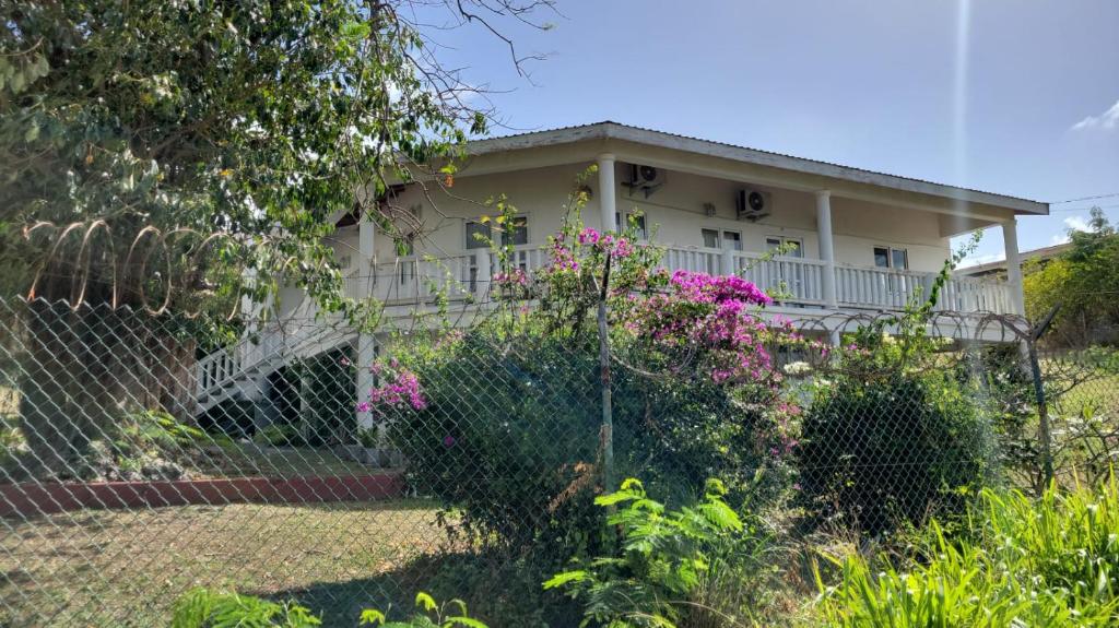 a house with a fence in front of it at A Serene Studio in Vieux Fort