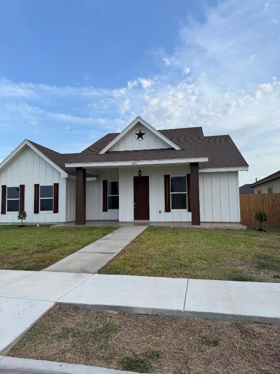 a white house with a black roof at Dream Casa Blanca in Harlingen
