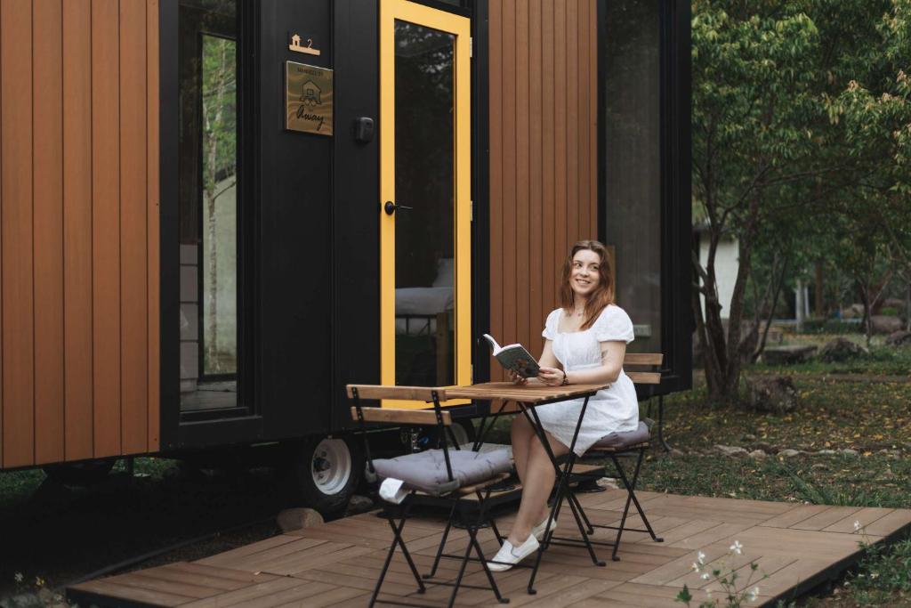 a woman sitting at a table with a laptop at Lanyin Hut in Shui-t'ien