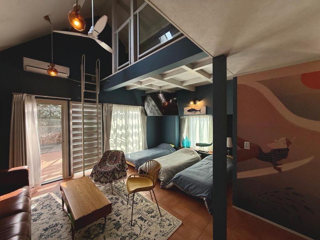 a room with a bunk bed and a desk and chair at saunalu in Kido