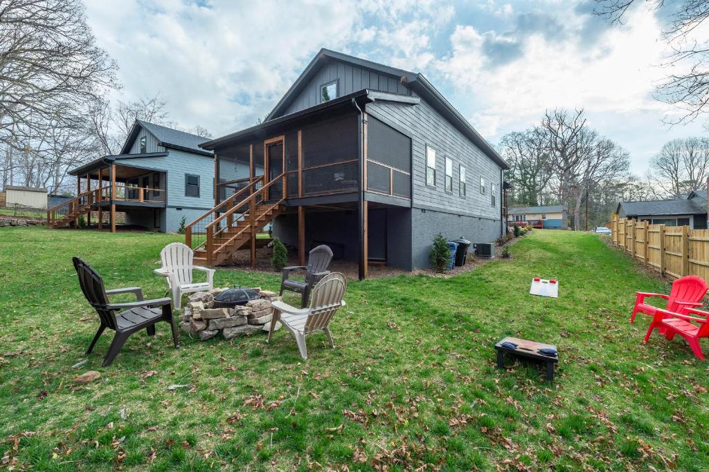 a house with chairs and a fire pit in the yard at Roam Inn in Black Mountain
