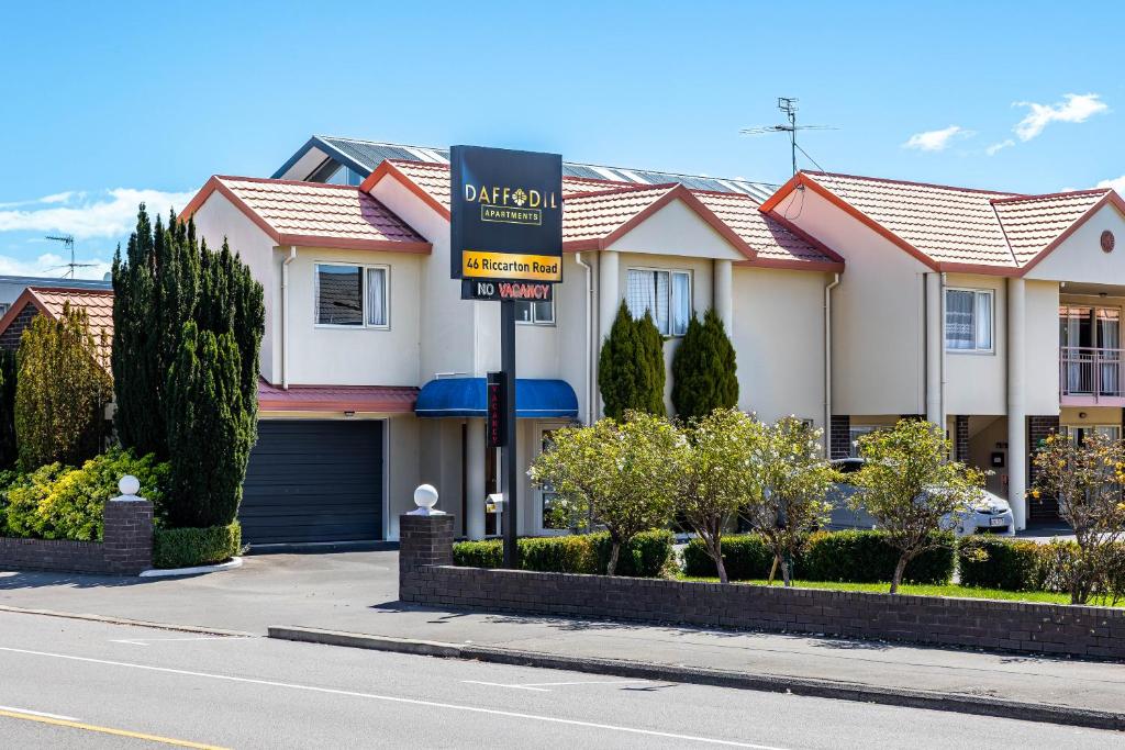a street sign in front of a house at Daffodil Apartments in Christchurch