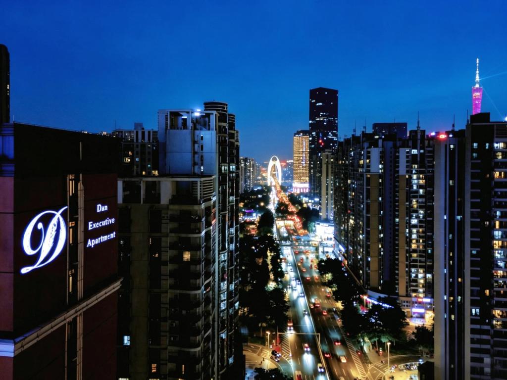 a view of a city at night with buildings at Dan Executive Apartment Guangzhou Zhujiang New Town in Guangzhou