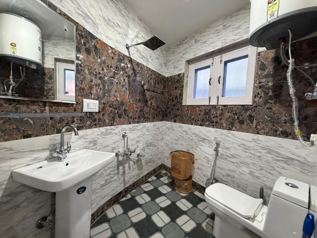 a bathroom with a sink and a toilet at FarahBakshResidency in Jāmb