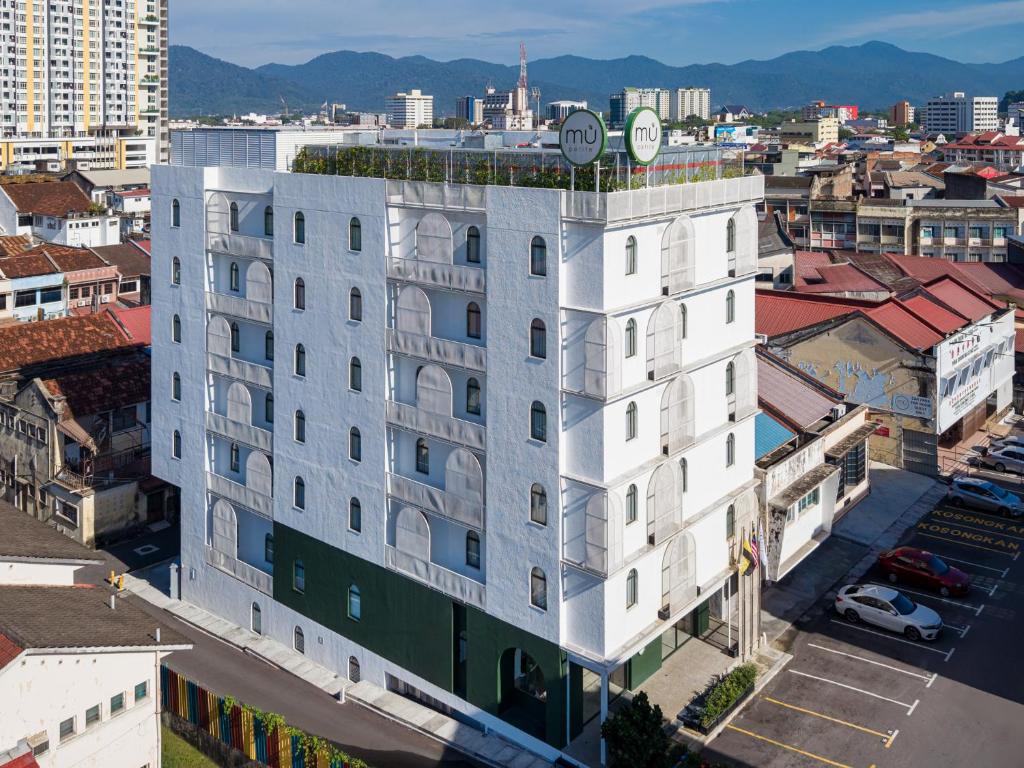 an apartment building with a clock on top of it at mu petite in Ipoh
