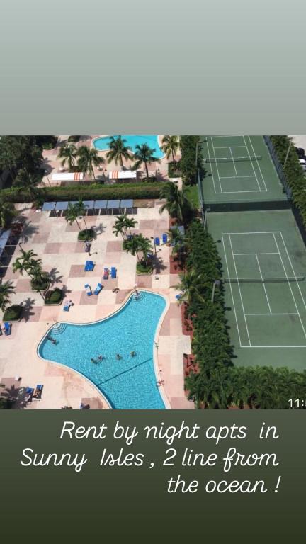 an aerial view of a resort with a tennis court at Apartments TVG Miami by the ocean ! in Miami Beach