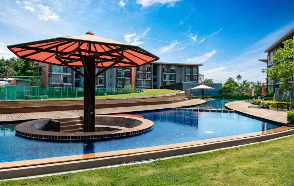 an umbrella sitting in the middle of a pool at Cozy 1-Bedroom Apartment Near Fisherman's Village in Nathon Bay
