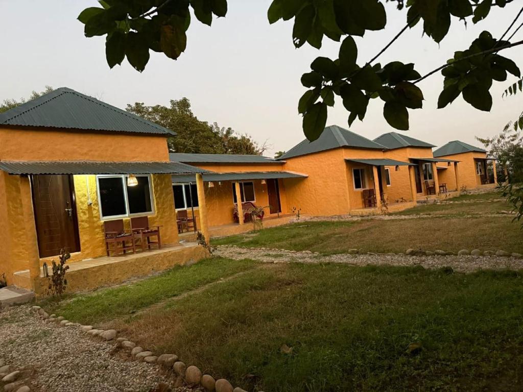 a row of houses with a yard in front of them at Chital lodge in Chitwan