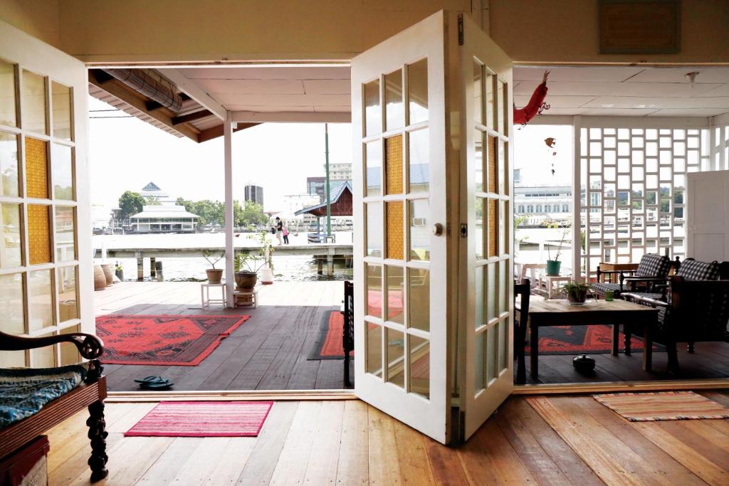 an open door to a porch with a view of a deck at Kunyit 7 Lodge in Bandar Seri Begawan