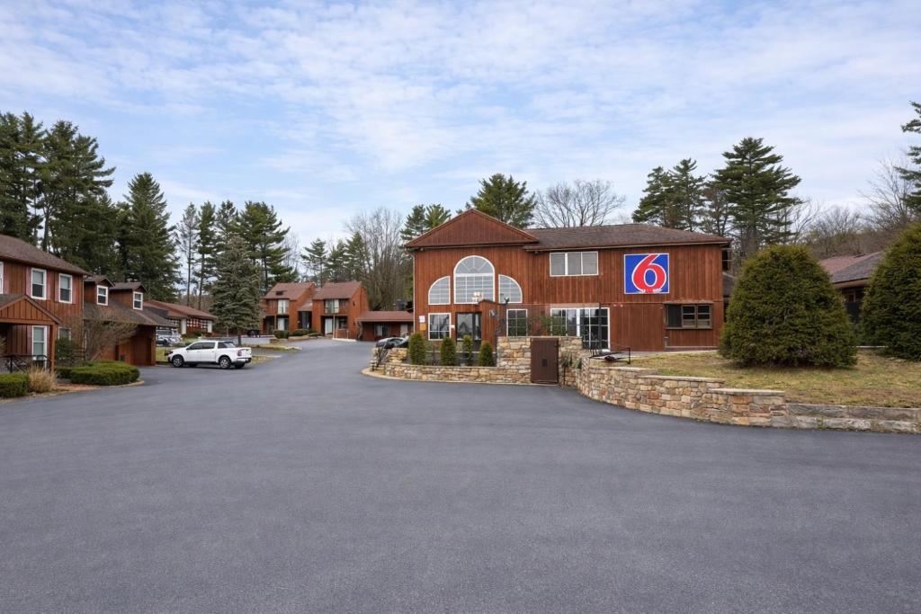 a car parked in front of a building at Studio 6 Lake George NY Adirondacks in Lake George