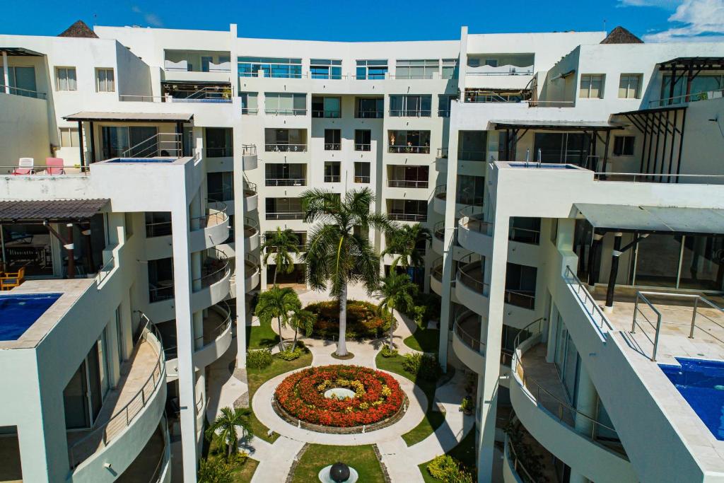 an aerial view of a building with a courtyard at Ocean-view condo with private rooftop pool, terrace, & resort-style pool in Nuevo Vallarta