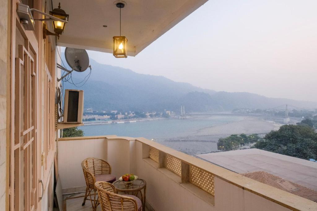 a balcony with a view of a river at Luxury 2 Bedroom's Appartment in Rishīkesh