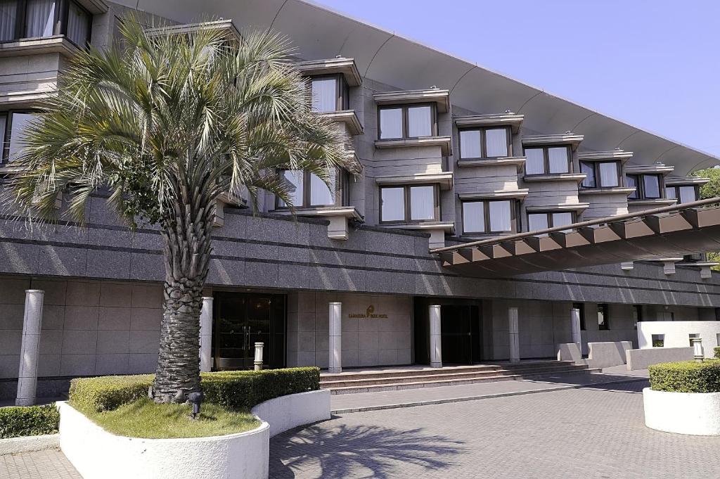 a palm tree in front of a building at Kamakura Park Hotel in Kamakura